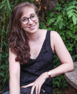 Photo of the author smiling in a garden